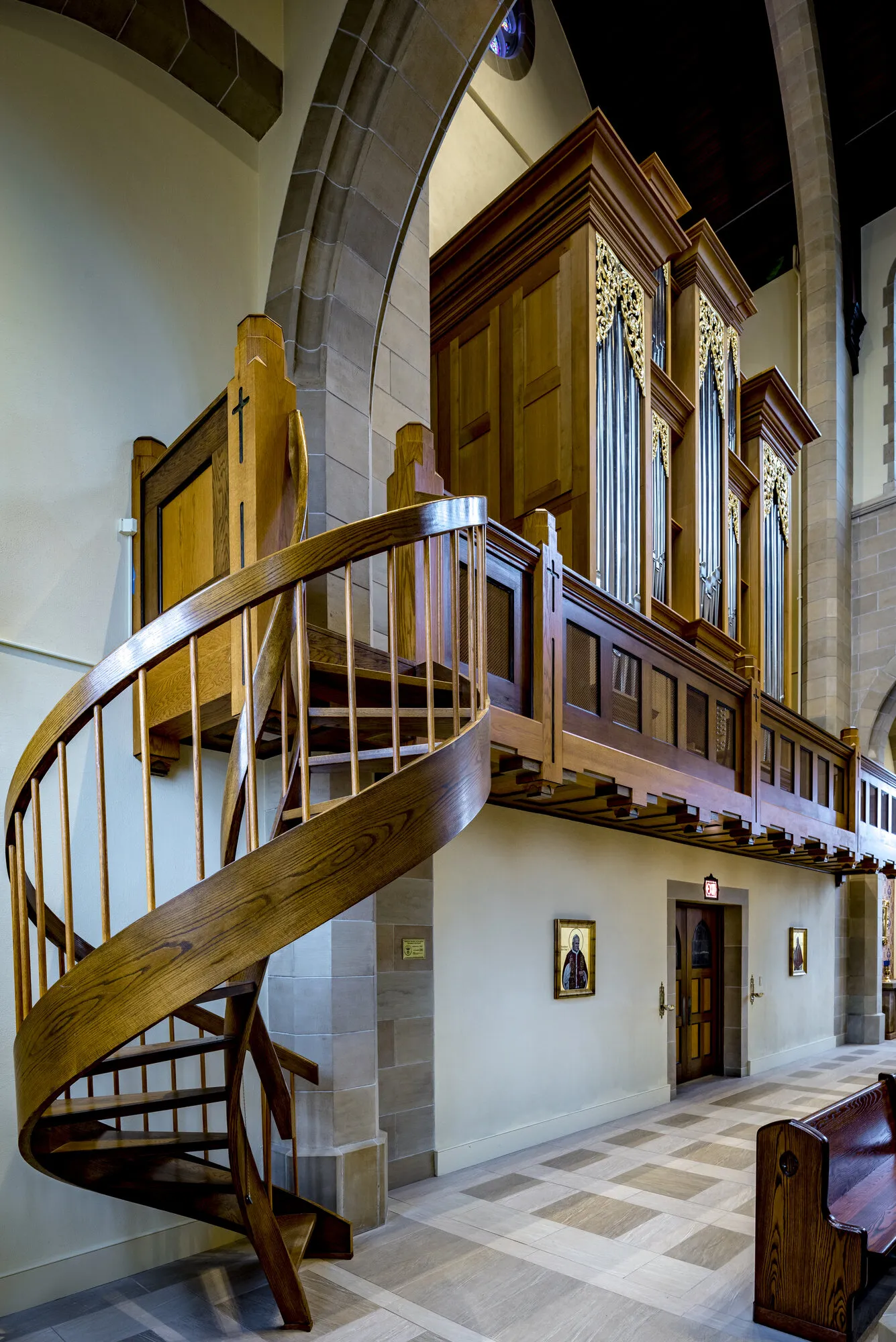 The oak spiral stair to the organ loft, with the organ case above.