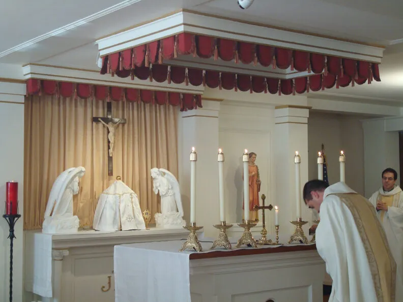 Rev Thomas Buffer, the parish pastor, vested and standing at the renovated altar during Mass.